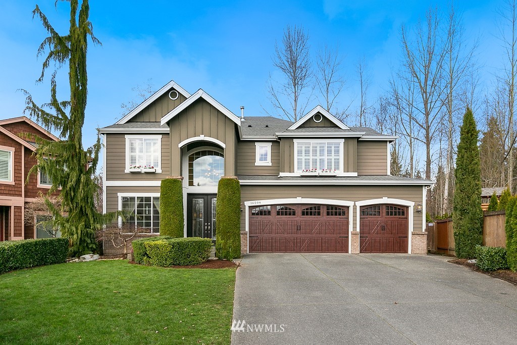16204 40th Avenue Southeast Bothell, WA 98012 - Photo 1 of 24 a front view of a house with a garden and yard