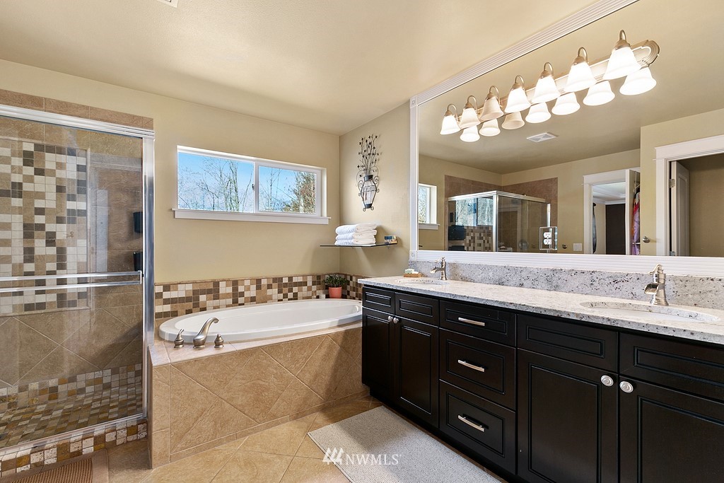 16204 40th Avenue Southeast Bothell, WA 98012 - Photo 14 of 24 a bathroom with a tub a sink double vanity and mirror
