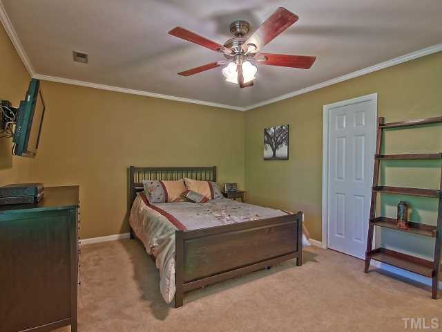 5527 Hamstead Crossing Raleigh, NC 27612 - Photo 5 of 5 a bedroom with a bed and a bookshelf