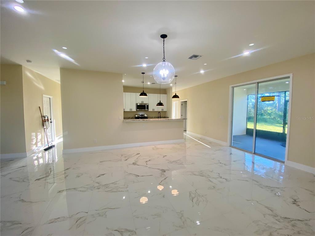 4449 Schumacher Road Sebring, FL 33872 - Photo 11 of 32 a view of a hallway with chandelier and living room