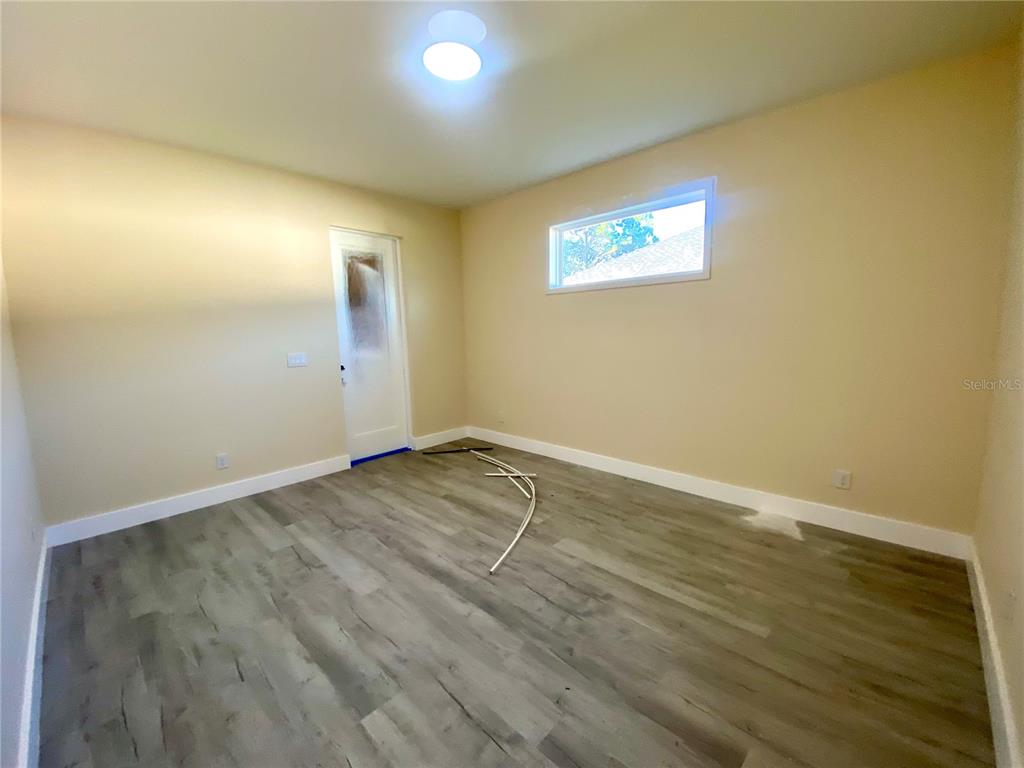 4449 Schumacher Road Sebring, FL 33872 - Photo 15 of 32 an empty room with wooden floor and windows
