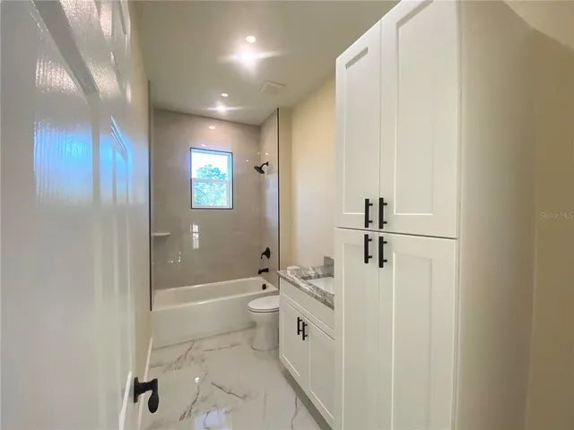 a bathroom with a bathtub a toilet and a shower