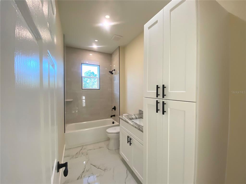 4449 Schumacher Road Sebring, FL 33872 - Photo 26 of 32 a bathroom with a bathtub a toilet and a shower