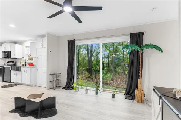 a living room with furniture and a floor to ceiling window
