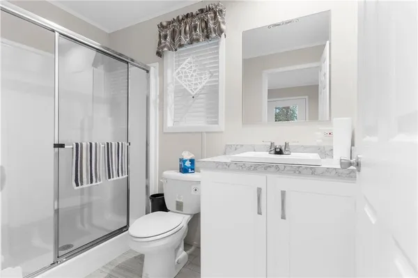 a bathroom with a sink toilet and shower