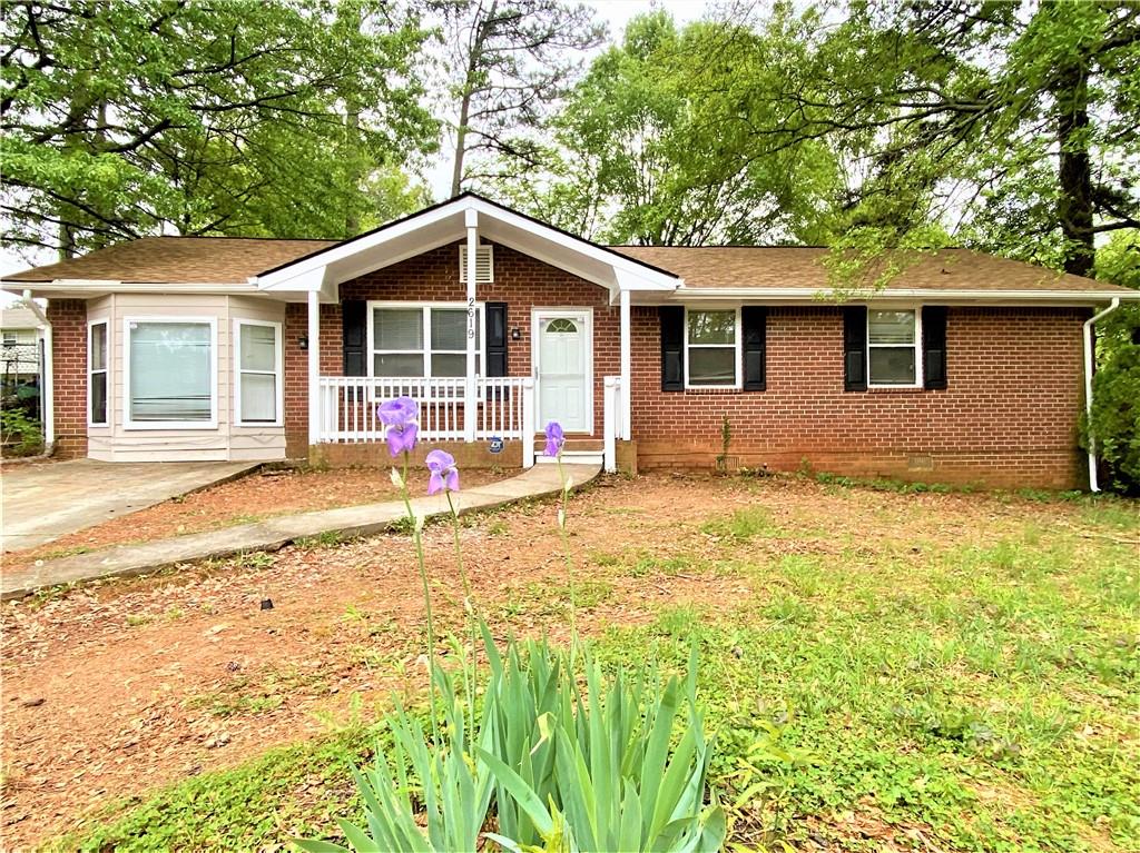 2619 Kelly Lake Road Decatur, GA 30032 - Photo 1 of 1 a house with trees in the background