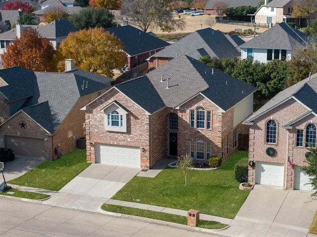 an aerial view of a house with a yard