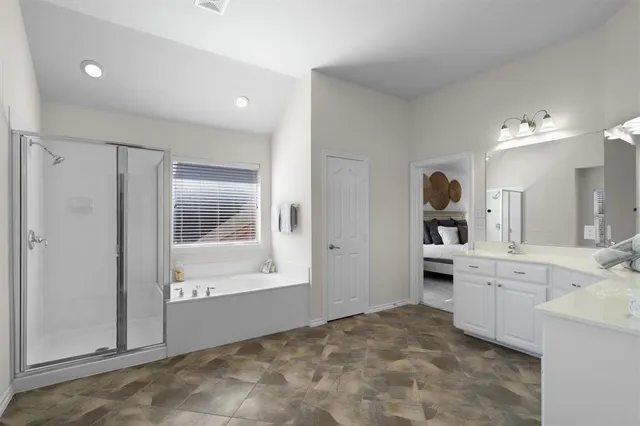 a large white kitchen with a sink and cabinets