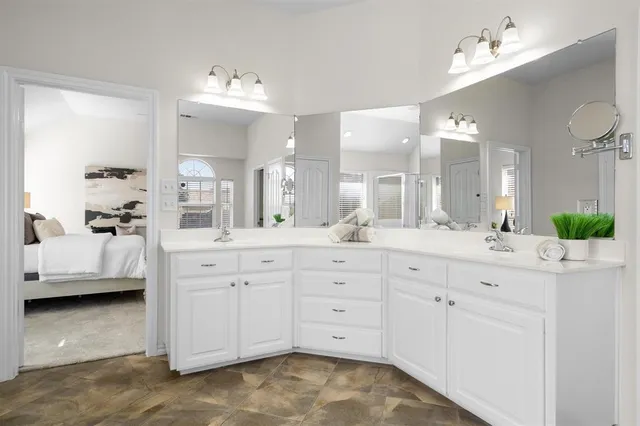 a spacious bathroom with a double vanity sink mirror and