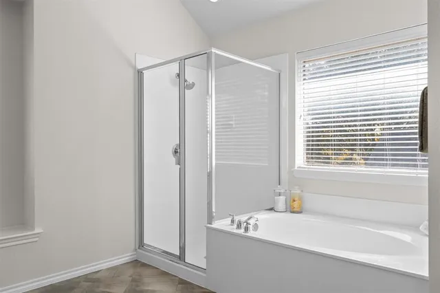 a bathroom with a bathtub and a shower