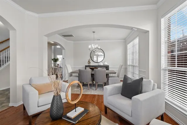 a living room with furniture a rug and a window