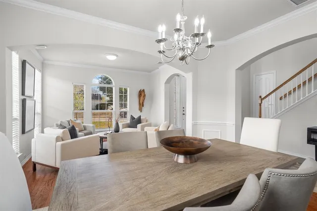 a view of a dining room with furniture and chandelier