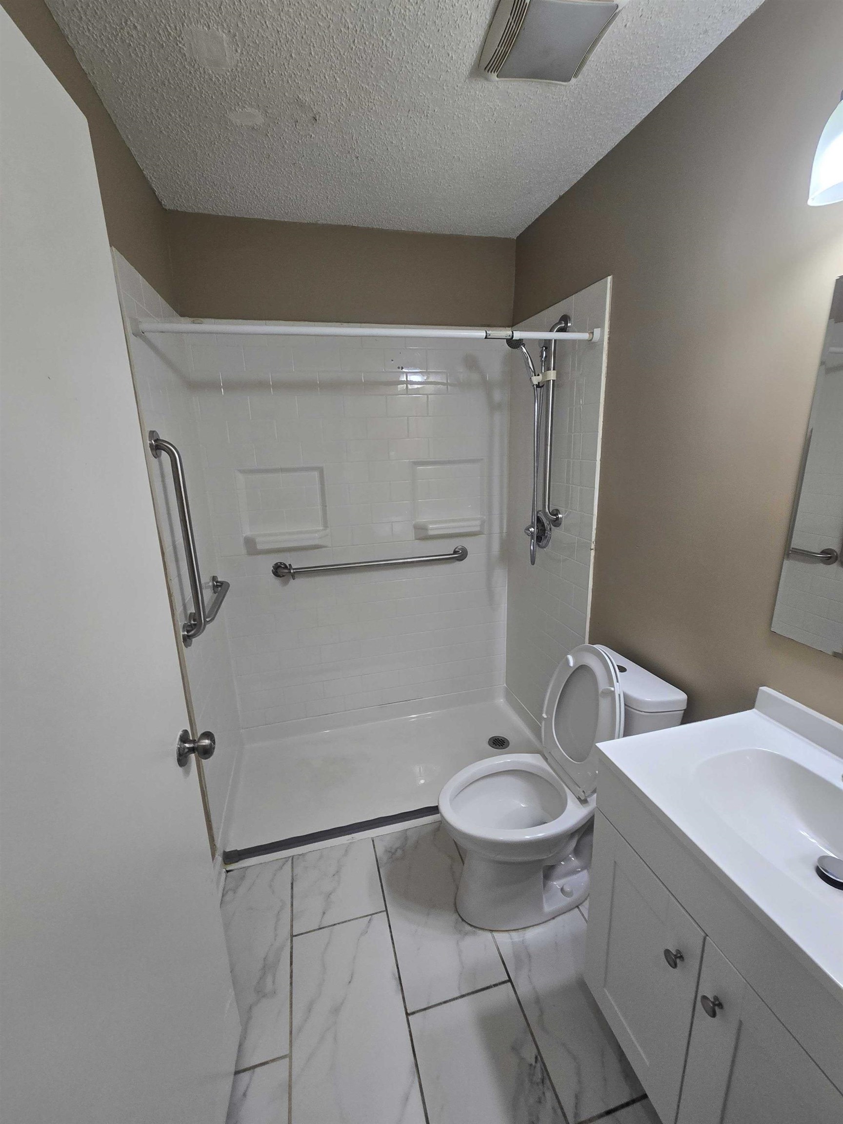 4511 Sumners Wells Road Memphis, TN 38118 - Photo 5 of 8 a bathroom with a granite countertop sink toilet and a mirror