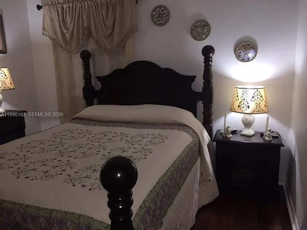 a bedroom with a bed and a lamp