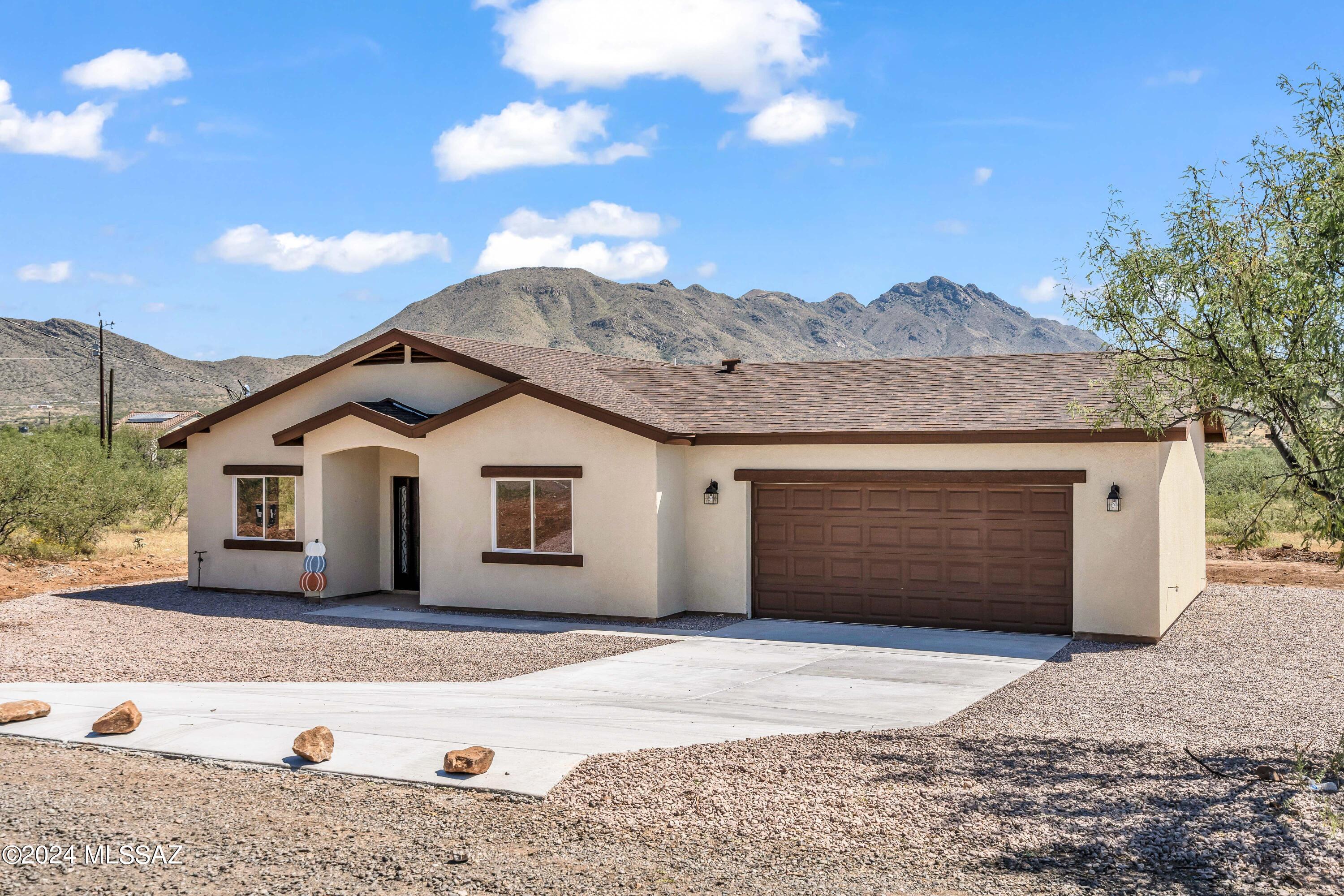 1849 Circulo Mexicali Rio Rico, AZ 85648 - Photo 1 of 29 a front view of a house with a yard and garage