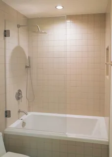 a bathroom with a bathtub and shower