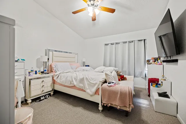 a bedroom with a bed and a flat tv screen
