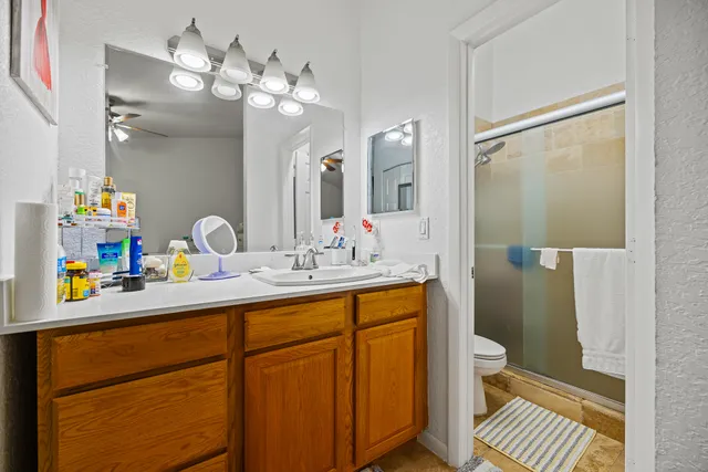 a bathroom with a sink a toilet and a mirror