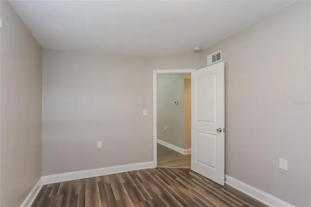 a view of bedroom with closet and wooden floor