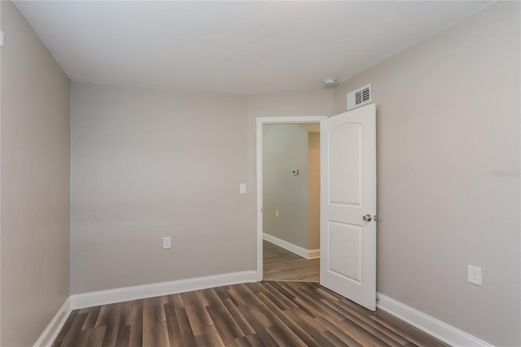 1960 Cecil Street Largo, FL 33774 - Photo 11 of 16 a view of bedroom with closet and wooden floor