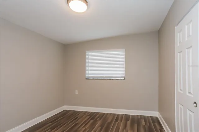 a view of room with window and hardwood floor