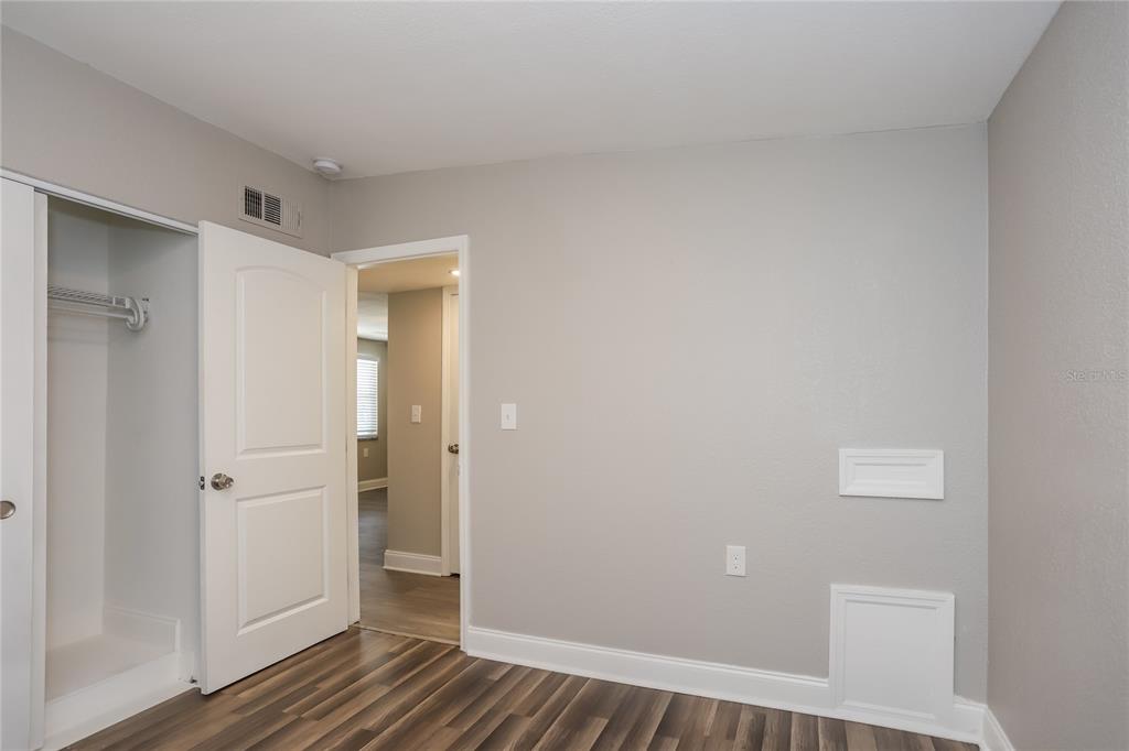 1960 Cecil Street Largo, FL 33774 - Photo 13 of 16 a view of a hallway with wooden floor and closet