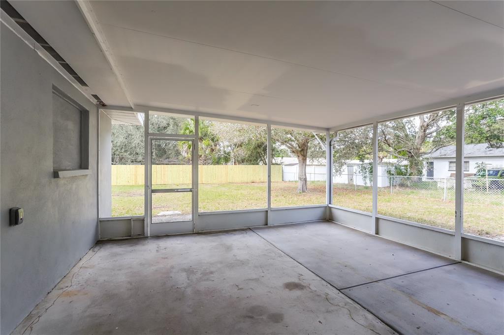 1960 Cecil Street Largo, FL 33774 - Photo 6 of 16 a view of an empty room with a large window