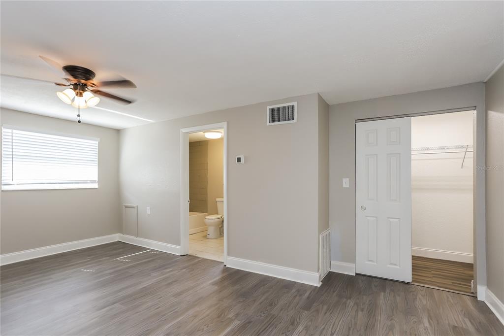 1960 Cecil Street Largo, FL 33774 - Photo 7 of 16 a view of empty room with wooden floor and fan