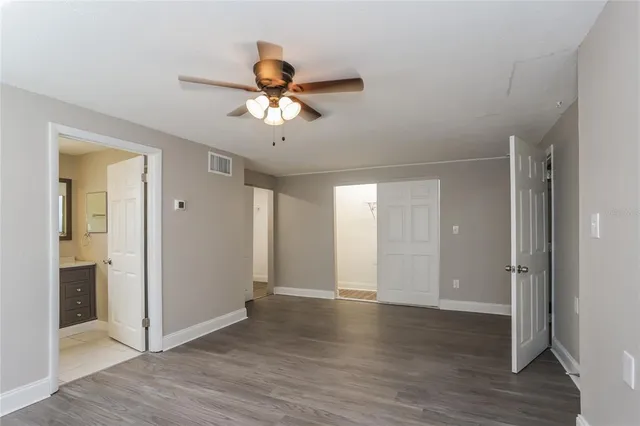 a view of an empty room with wooden floor