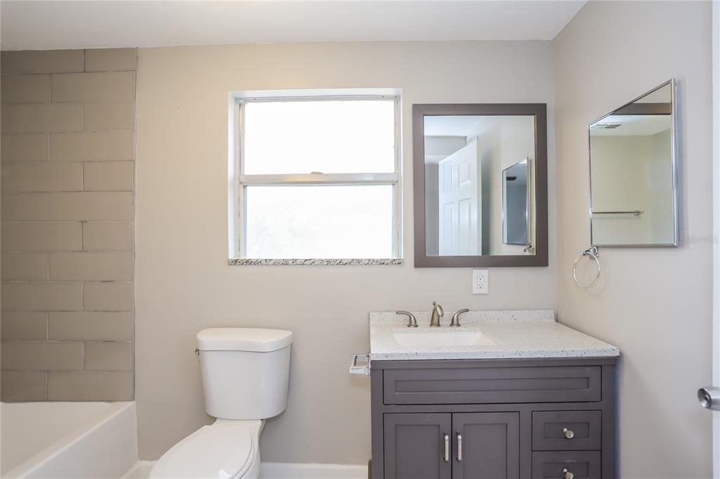 1960 Cecil Street Largo, FL 33774 - Photo 9 of 16 a bathroom with a sink a toilet and shower