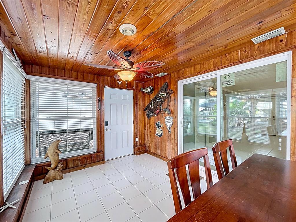 13429 Lisa Drive Hudson, FL 34667 - Photo 11 of 26 a view of a porch with furniture and floor to ceiling window