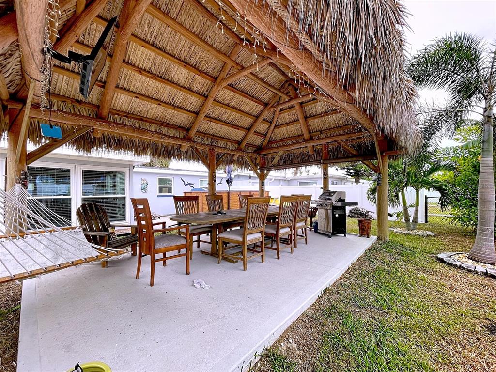 13429 Lisa Drive Hudson, FL 34667 - Photo 18 of 26 a view of a big patio with table and chairs under an umbrella