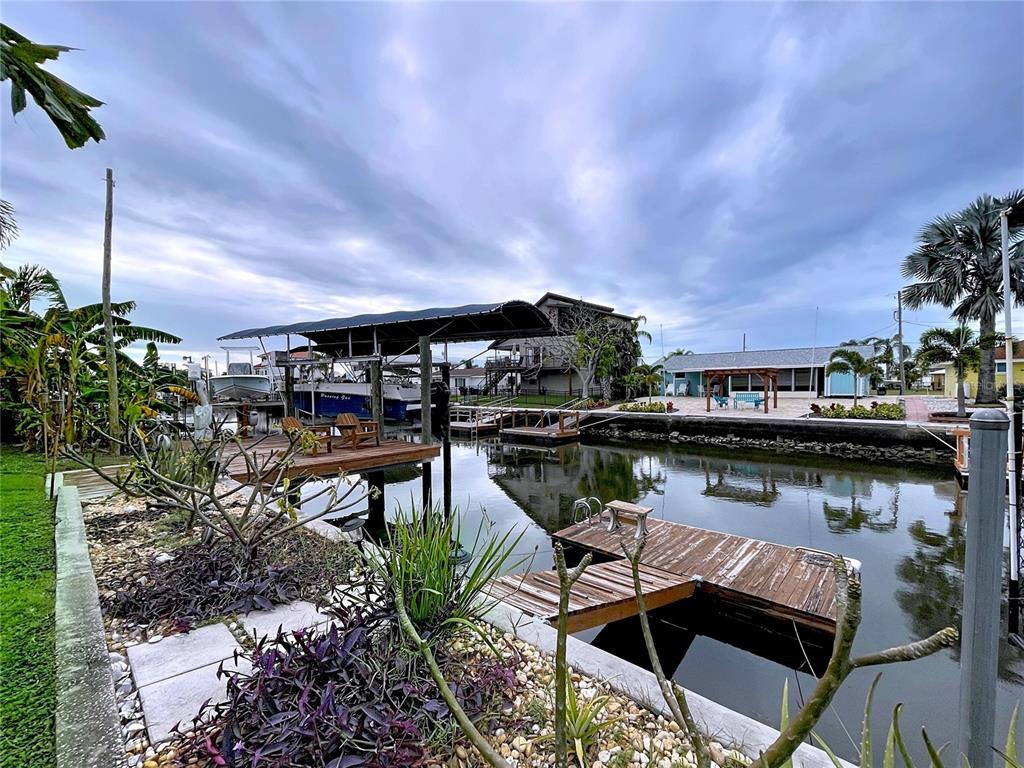 13429 Lisa Drive Hudson, FL 34667 - Photo 24 of 26 a view of house with lake view and sitting space