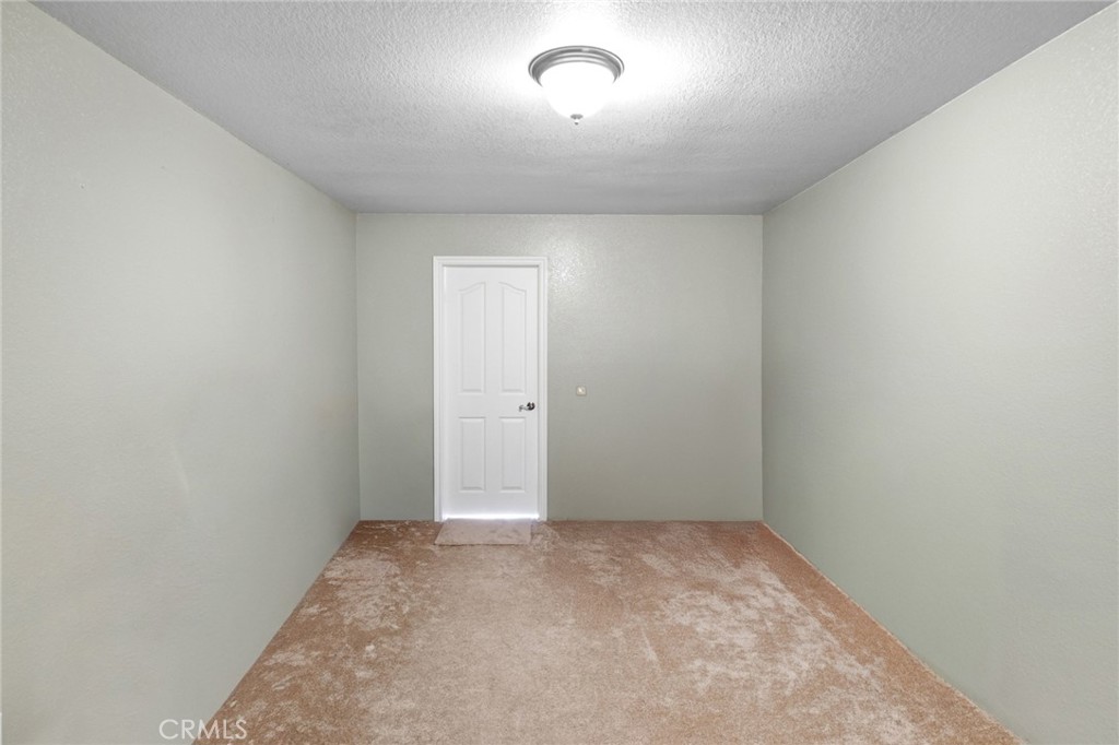 11025 El Esteban Road Phelan, CA 92371 - Photo 22 of 54 an empty room with a empty space and windows