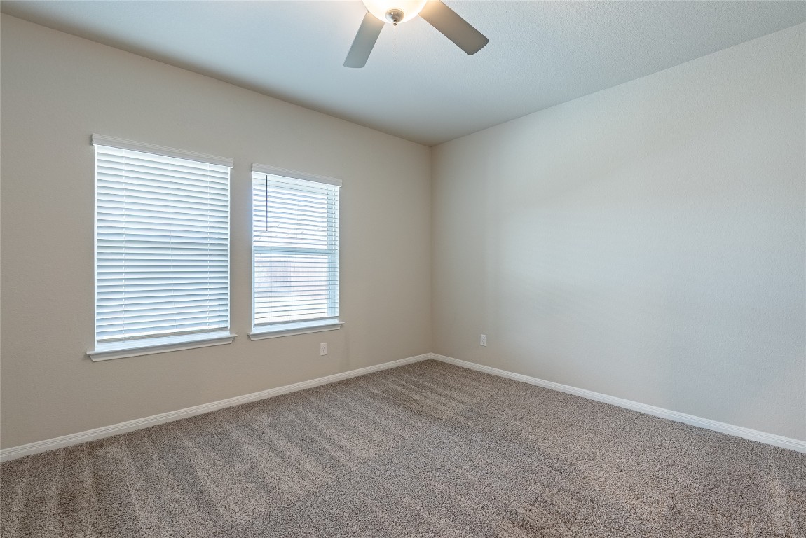 107 Cona Way Hutto, TX 78634 - Photo 11 of 26 Carpeted empty room with baseboards and a ceiling fan