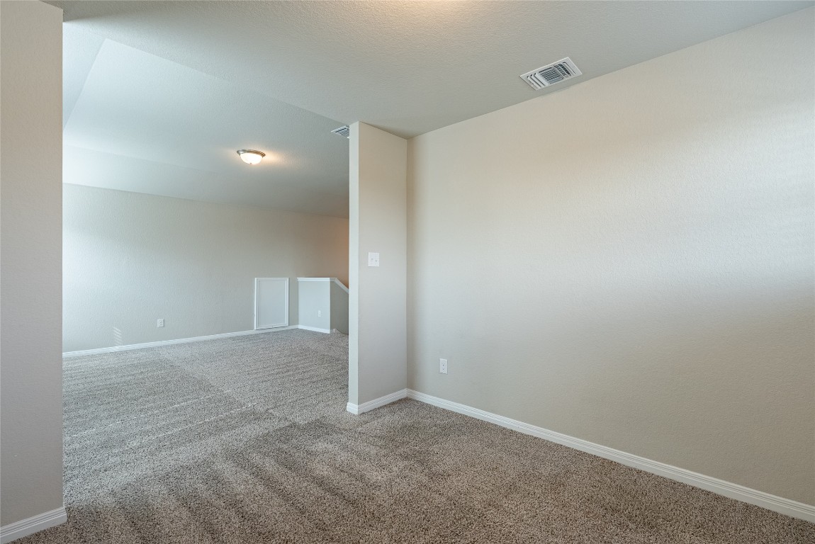 107 Cona Way Hutto, TX 78634 - Photo 17 of 26 Carpeted spare room featuring baseboards