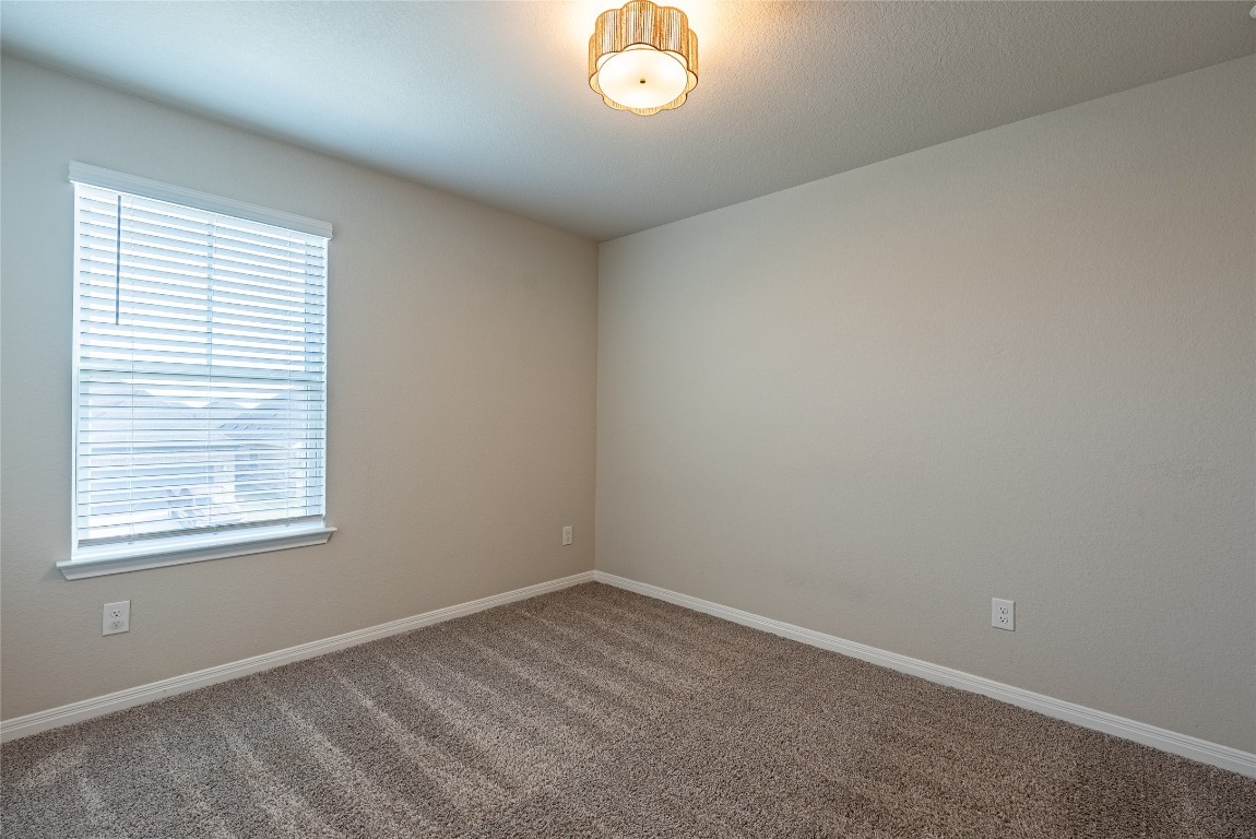 107 Cona Way Hutto, TX 78634 - Photo 18 of 26 Carpeted spare room with baseboards