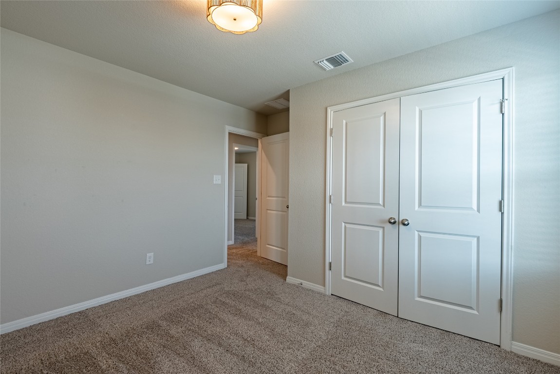 107 Cona Way Hutto, TX 78634 - Photo 19 of 26 Unfurnished bedroom with light carpet and a closet