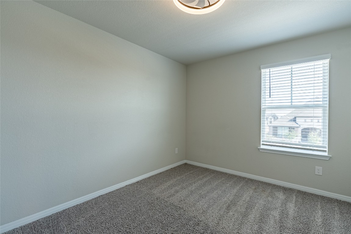 107 Cona Way Hutto, TX 78634 - Photo 20 of 26 Empty room with baseboards and carpet flooring