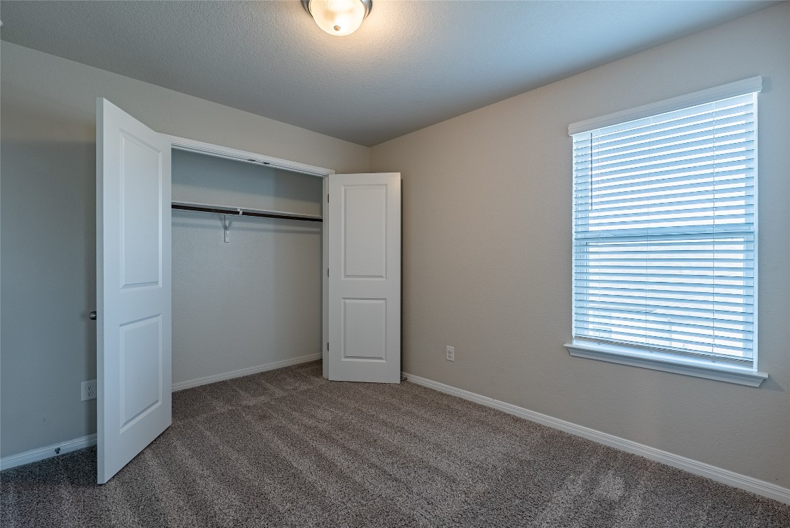 107 Cona Way Hutto, TX 78634 - Photo 22 of 26 Unfurnished bedroom with carpet floors and a closet