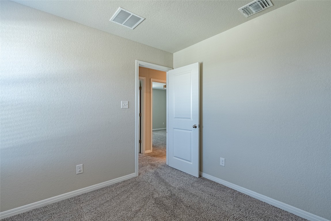 107 Cona Way Hutto, TX 78634 - Photo 23 of 26 Carpeted spare room featuring baseboards