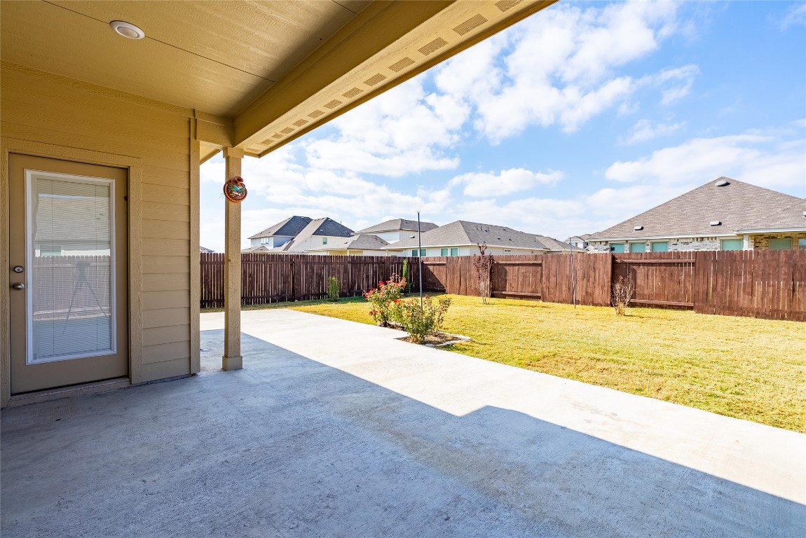 107 Cona Way Hutto, TX 78634 - Photo 25 of 26 Fenced backyard with a patio and a residential view