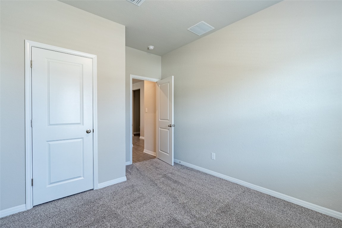 107 Cona Way Hutto, TX 78634 - Photo 8 of 26 Unfurnished bedroom with carpet floors and baseboards