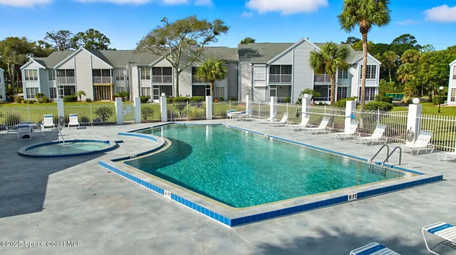 a view of a house with swimming pool and a yard