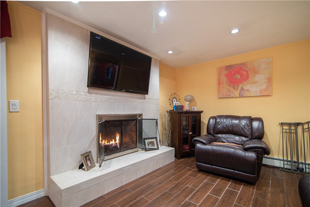 28 Greenbrier Road Smithfield, RI 02828 - Photo 9 of 14 Sitting area open to kitchen features wood burning fireplace.