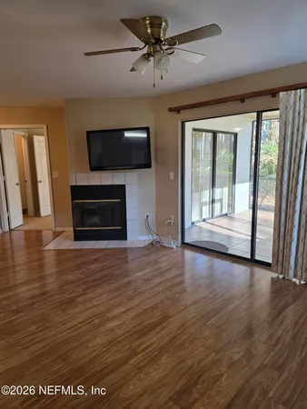 wooden floor in an empty room with a window