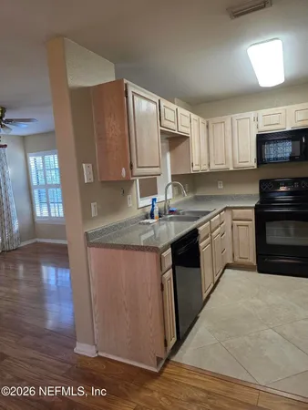 a stove top oven sitting inside of a kitchen