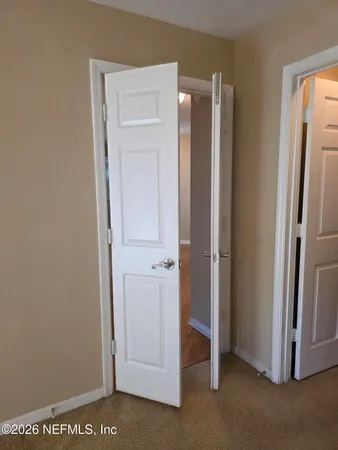 a view of walk in closet with empty racks