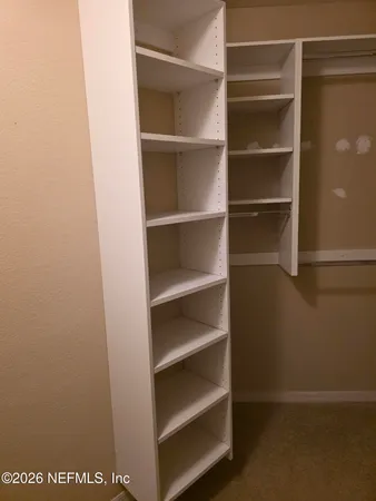 a view of an empty room with a window