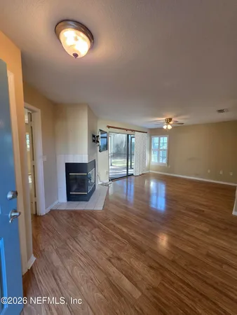 a view of a kitchen with a sink and a refrigerator